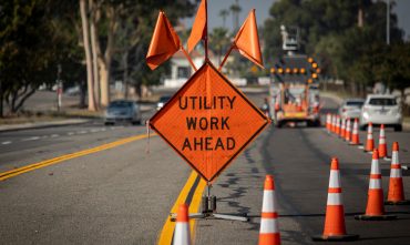 Traffic,Sign,With,Flags,Reading,Utilitary,Work,Ahead,With,Traffic Traffic,Sign,With,Flags,Reading,Utilitary,Work,Ahead,With,Traffic